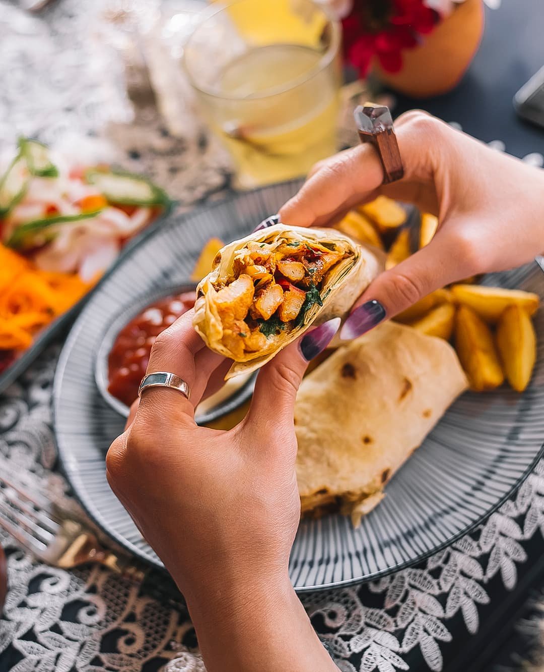 woman-holding-chicken-shawarma-flatbread-served-with-fries-sauces-yogurt-pickles 1